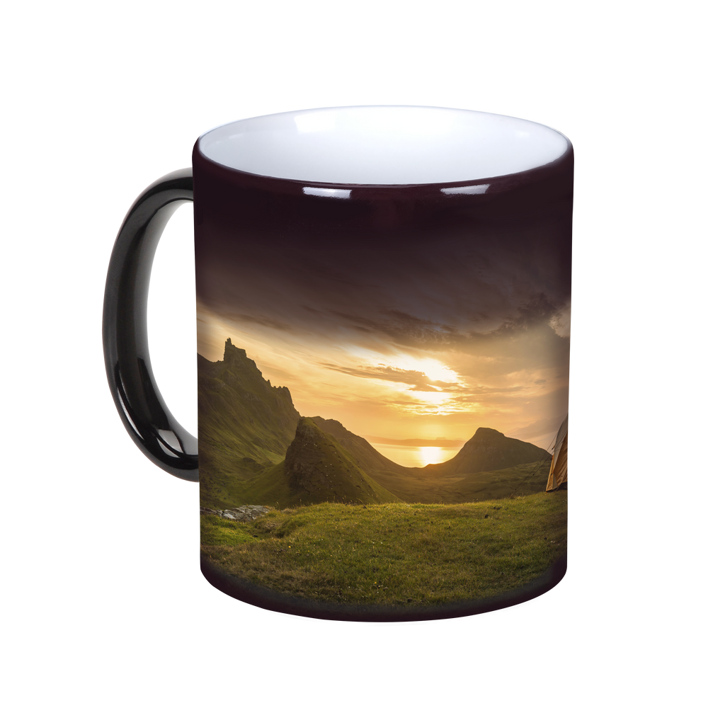 A Magic Photo Mug from Fuji Personalized Photo Products with an image of a mountain and sunset revealed when a hot beverage is poured in.