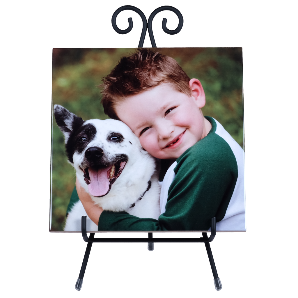 A photo of a boy hugging a dog, displayed on a metal stand as a Fuji Personalized Photo Products Ceramic Photo Tile with Stand.