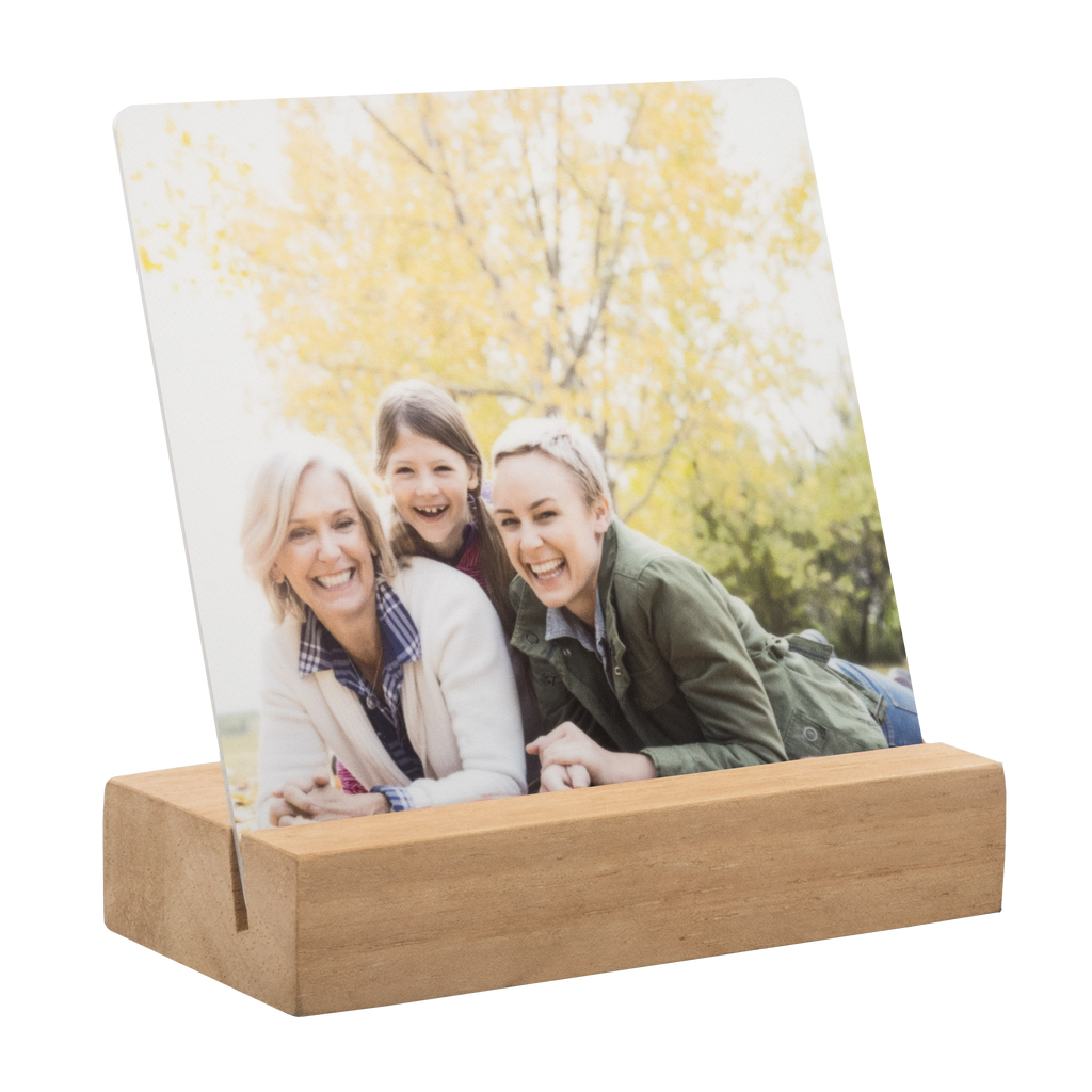 A Metal Desk Print photo of a family sitting on a wooden box by Fuji Personalized Photo Products.