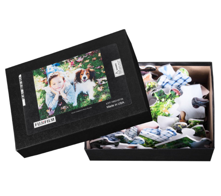 A personalized, custom puzzle featuring a photo of a girl and a dog, partially assembled inside an open box with the Best Photo Puzzle's image on the lid.