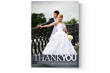 A personalized wedding thank-you card featuring a newlywed couple standing by a railing, crafted by Photo Book Press.