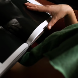 A woman is holding a Photo Book Press Premium Photo Book in her hands.