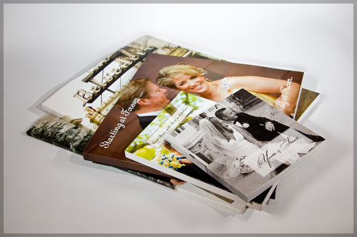 A stack of affordable Photo Book Press Premium Soft Cover Photo Books with a couple of pictures.
