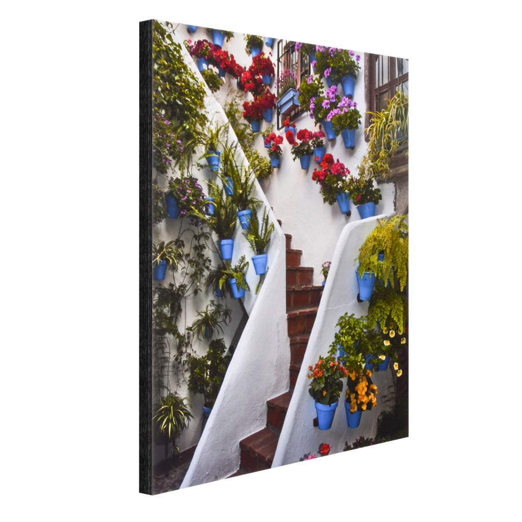 A staircase with elegant Fuji Personalized Photo Products mounted prints of blue pots and flowers on it.