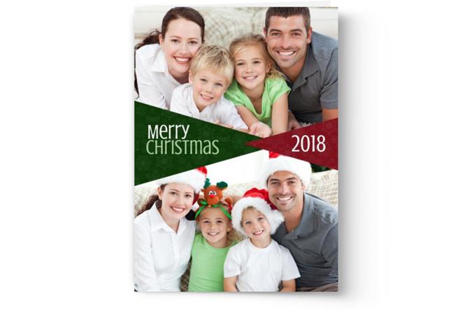 A personalized Christmas card from 2018 featuring a smiling family of four with a festive greeting designed by Photo Book Press.