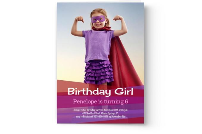 A young girl dressed as a superhero with a purple mask and cape stands with her fists on her hips on a Photo Book Press Create & Print Kid's Photo Birthday Party Invitation.