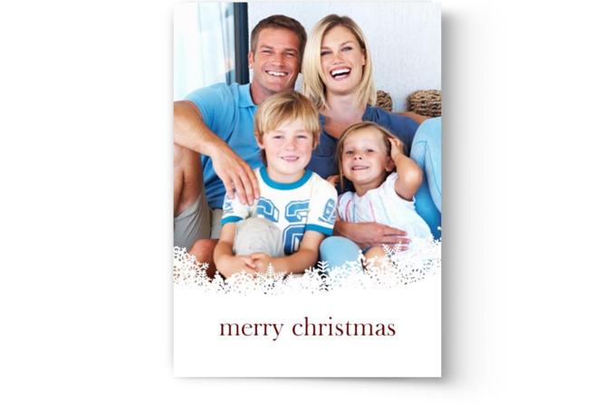 A photo of a family with the words merry Christmas printed on Photo Book Press personalized Christmas cards.