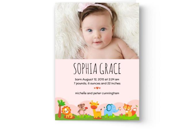 Custom printed birth announcement photo cards by Photo Book Press featuring a photograph of an infant with name, birth details, and a decorative animal border.