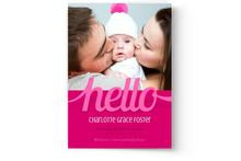 Parents affectionately kissing their baby on the cheeks for a Photo Book Press Birth Announcement Photo Card.