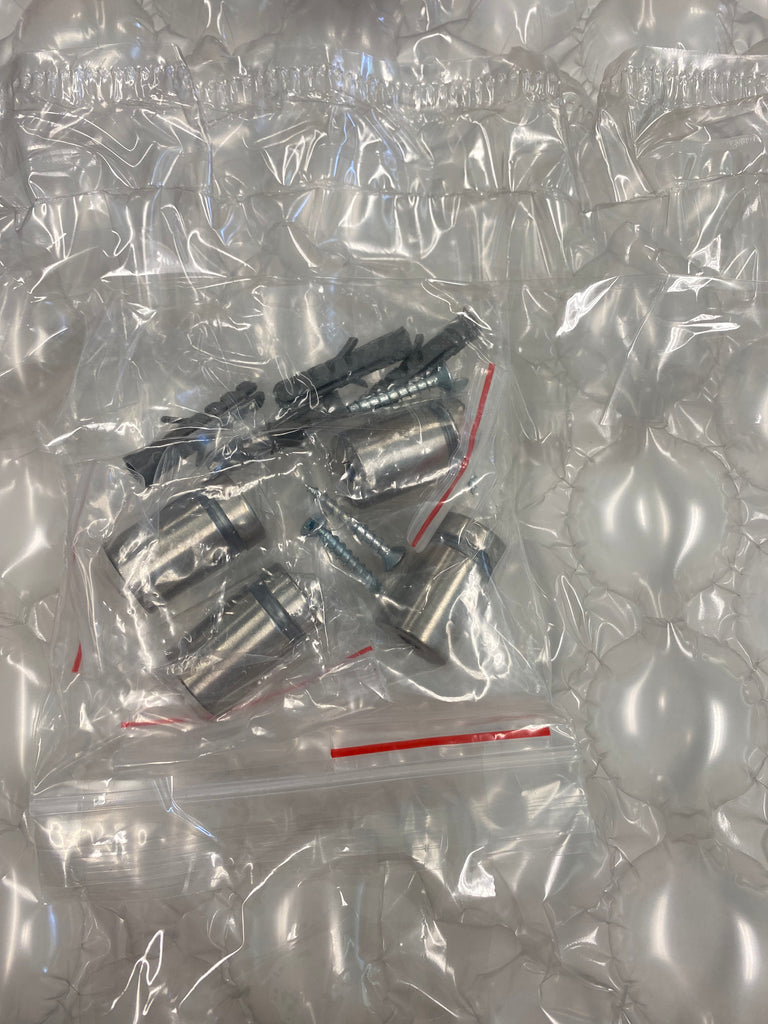 Metal hardware components, including mounting hardware, sealed in a Photo Book Press plastic bubble wrap bag.