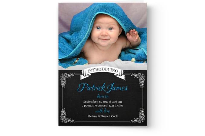A custom printed baby announcement card by Photo Book Press, featuring a smiling baby wrapped in a blue towel with the child's name, birth details, and parents' names.